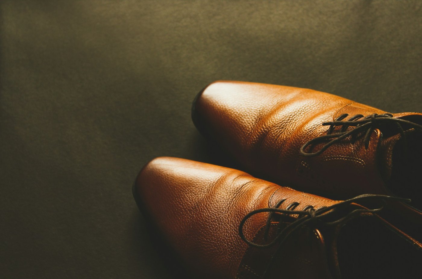 Brown leather dress shoes typical of long warehouse dwell and ocean export